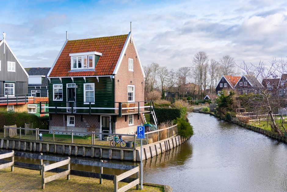 Picturesque Dutch house by a canal in Marken, North Holland, showcasing traditional architecture.